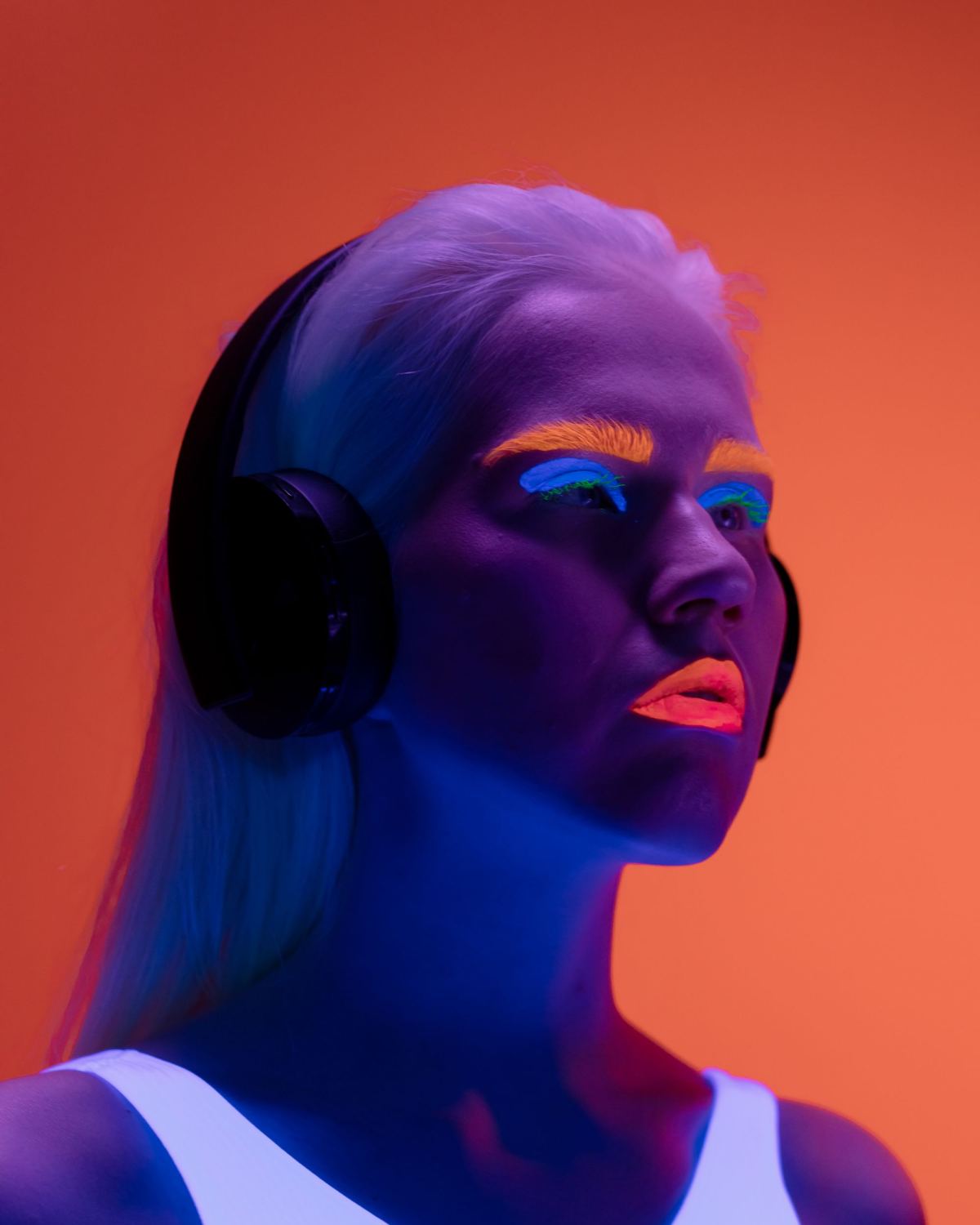Creator with studio headphones under neon light